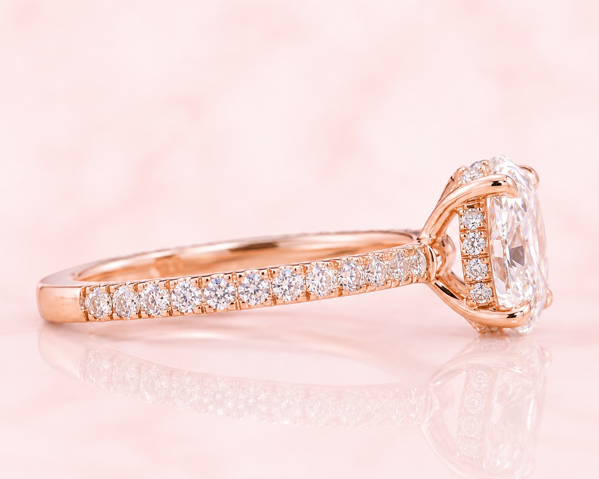 Oval lab grown diamond engagement ring with hidden halo and pave band in rose gold