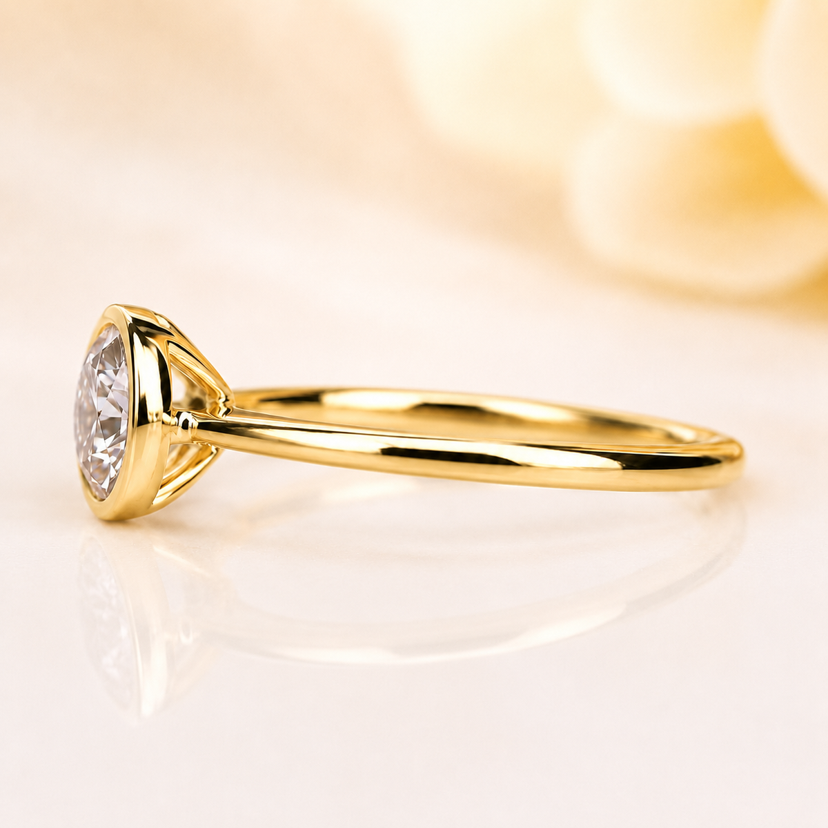 Bezel set round lab grown diamond solitaire engagement ring in yellow gold