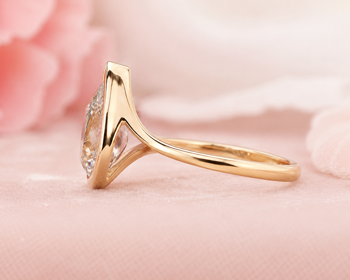 Pear shaped engagement ring with timeless and unique design in yellow gold
