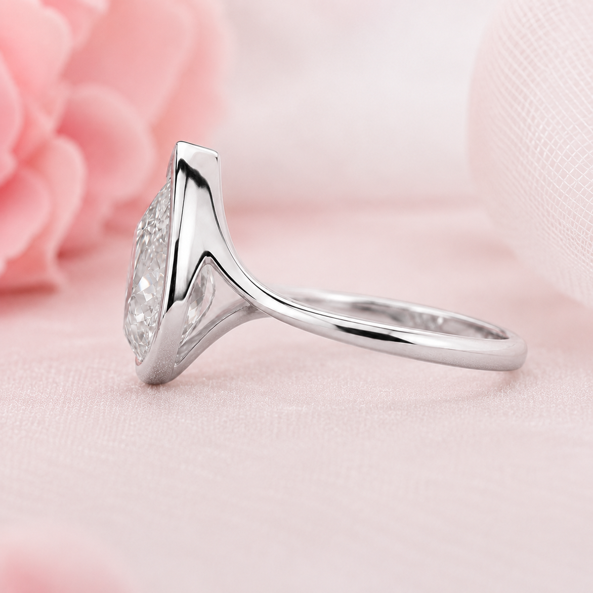 Pear shaped engagement ring with timeless and unique design in white gold